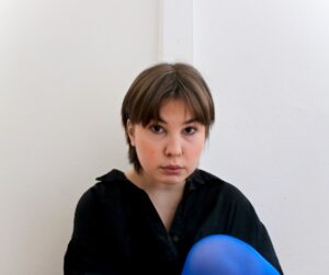 Portrait of a person sitting on a floor